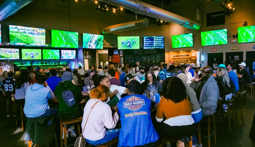 People inside eating and watching television.